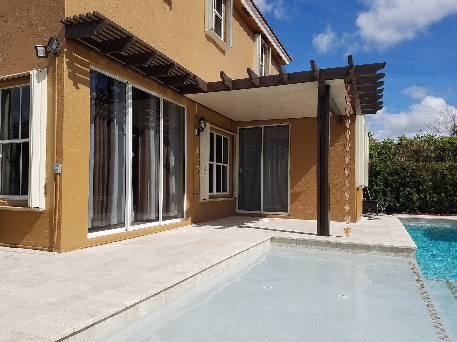 Motorized louvered pergola over a pool deck in Dr Phillips FL